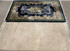 TWO WASHED WOOLEN RUGS - MID TO LATE 20TH CENTURY, cream ground example, embossed central floral
