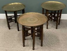 THREE BENARES TYPE BRASS TOP TABLES, circular tray tops, animal and floral engraved details, six-leg