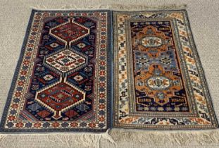 TWO EASTERN WOOLEN RUGS, red, cream and blue ground, the larger with repeat pattern central