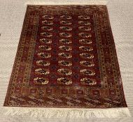 GOOD PERSIAN RED GROUND RUG, central block pattern of thirty matching motifs, multi bordered edging,