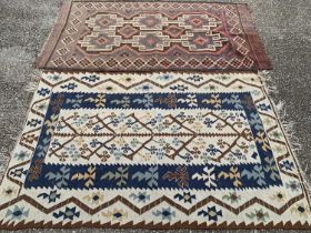TWO EASTERN STYLE WOOLEN RUGS, purple and red ground example, central stepped block motif, multi