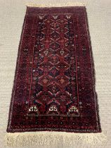 EASTERN WOOLEN RUG, red ground, repeating central diamond block pattern, multi bordered edge,