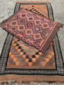 TWO EASTERN STYLE WOOLEN RUGS, rust and red ground, both having multiple zig-zag pattern detail,