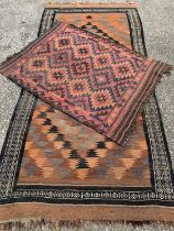 TWO EASTERN STYLE WOOLEN RUGS, rust and red ground, both having multiple zig-zag pattern detail,