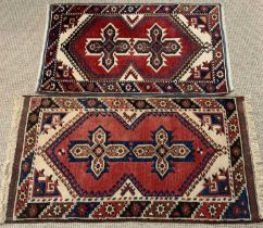 TWO TURKISH WOOLEN RUGS, red ground, near matching traditional motif central blocks, single bordered