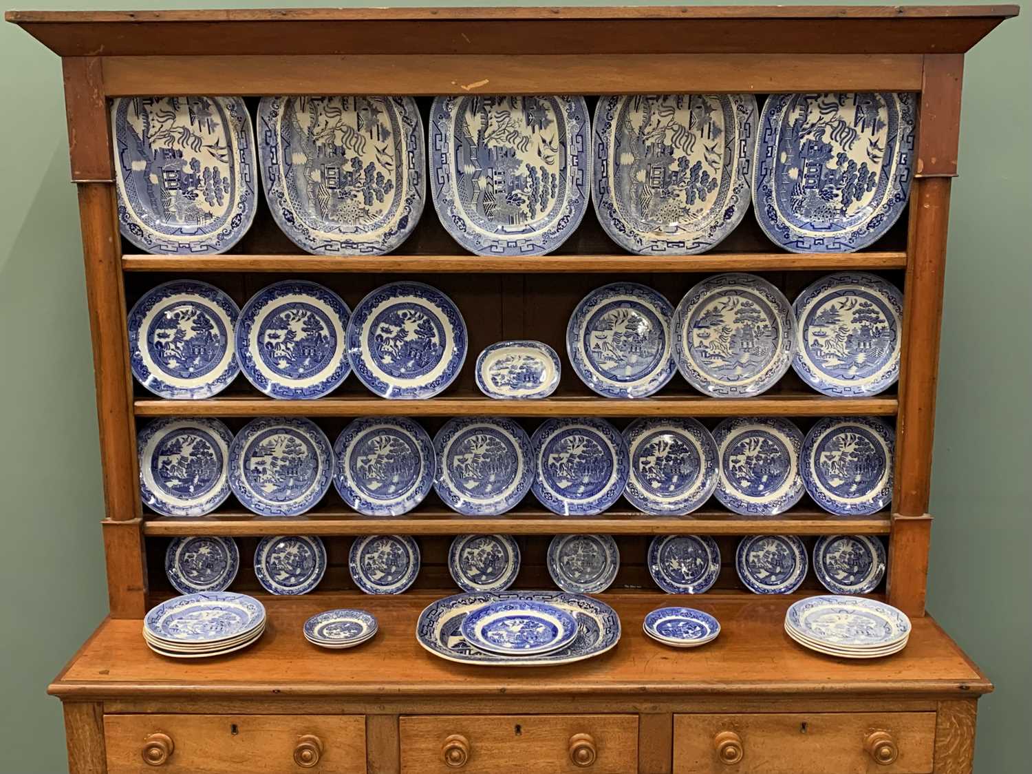 HARLEQUIN BLUE & WHITE WILLOW PATTERN POTTERY DRESSER SET, 46 pieces, to include six 40 x 32cms