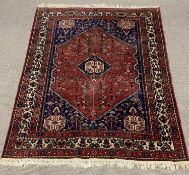 EASTERN WOOLEN RED AND BLUE GROUND RUG, traditional multi pattern central diamond and corner motifs,
