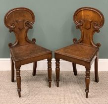 PAIR VICTORIAN OAK SHIELD BACK HALL CHAIRS, scrolled detail to the backs, solid seats, turned