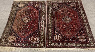 TWO EASTERN WOOLEN RUGS, similarly designed traditional patterns, mixed blue and red ground, multi