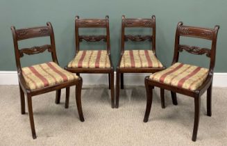 SET OF FOUR REGENCY MAHOGANY SABRE LEG CHAIRS, slightly curved backs, scroll and leaf carved