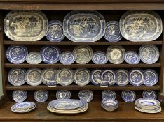 SIXTY PIECE WILLOW PATTERN POTTERY DRESSER SET, comprising eight various meat platters, 46 x 36cms