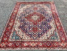 TABRIZ RUG, blue and red ground with traditional central diamond motif and wide border, 290 x