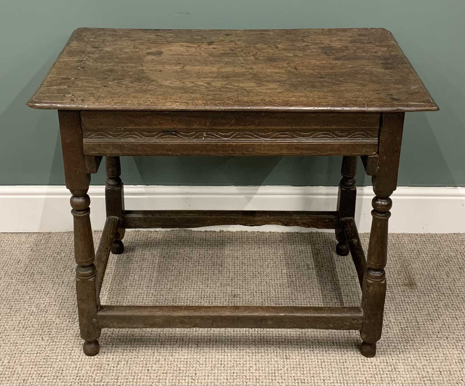 ANTIQUE OAK SINGLE DRAWER TABLE circa 1800, planked top, moulded edge, carved drawer front, peg