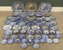 HARLEQUIN BLUE & WHITE WILLOW PATTERN DRESSER SET 65 pieces to include six various meat platters, 46