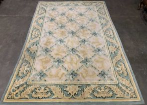 EASTERN STYLE WOOLLEN RUG, pure new wool pile, muted green and gilt tones, Tudor style central block