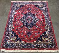 LARGE EASTERN STYLE WOOLEN RUG, traditional style central medallion, red and blue ground,