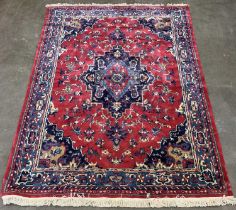 LARGE EASTERN STYLE WOOLEN RUG, traditional style central medallion, red and blue ground,