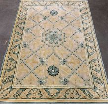 EASTERN STYLE WOOLLEN RUG, muted green and gilt tones, Tudor style central block pattern, leaf
