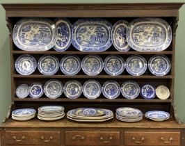 55 PIECE HARLEQUIN 'WILLOW' PATTERN POTTERY DRESSER SET, to include nine various platters, 45.5 x