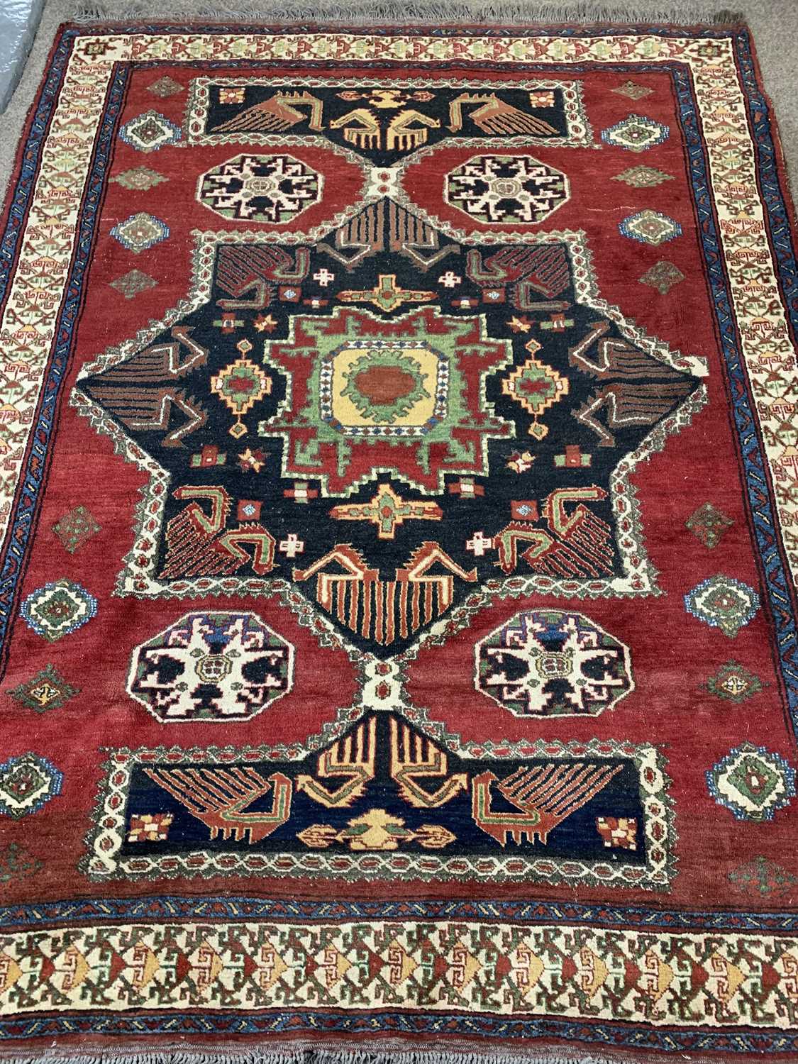 PERSIAN RED GROUND HANDMADE WOOL RUG, centre medallion, geometric border, 232 x 184cms Provenance: