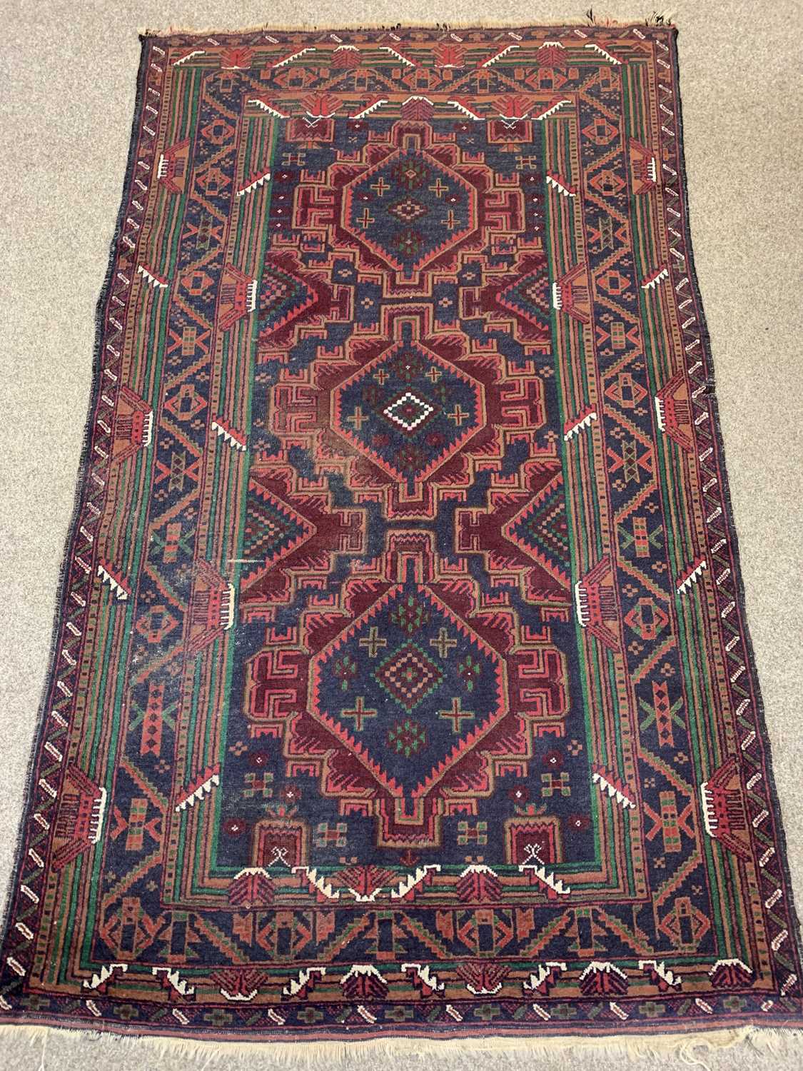 PERSIAN RED/BLUE GROUND HANDMADE WOOL RUG, triple medallion centre, geometric border, 192 x 113cms