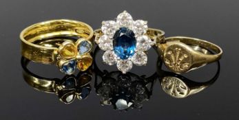 THREE GOLD RINGS, comprising a continental wide band ring with colourful stone four-leaf clover