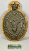 A VINTAGE CAST IRON WALL PLAQUE, Cheshire Constabulary, mounted on a mahogany back plate, 48 (h) x
