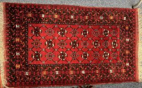 AFGHAN RED GROUND HANDMADE WOOL RUG, 154 x 90cms Provenance: deceased estate Conwy