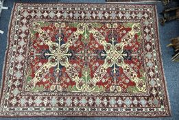 PERSIAN RED BLUE & CREAM GROUND HANDMADE WOOL RUG, floral border, 250 x 188cms Provenance: