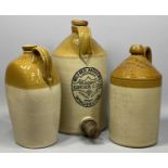 THREE ANTIQUE STONEWARE FLAGONS, Wilfred Andrews St Swithuns, draught ginger beer, 43cms (h),