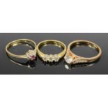 THREE VINTAGE DRESS RINGS comprising two gold and one plated, the first stamped 750, 3 claw