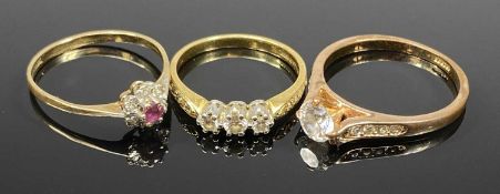 THREE VINTAGE DRESS RINGS comprising two gold and one plated, the first stamped 750, 3 claw