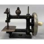 VICTORIAN CHILDS CAST IRON HAND SEWING MACHINE, crank with ceramic handle, 17cms (h) Provenance: