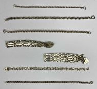 SEVEN SILVER BRACELETS comprising three gate link with padlock clasps, box link bracelet and three