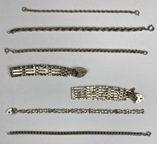 SEVEN SILVER BRACELETS comprising three gate link with padlock clasps, box link bracelet and three