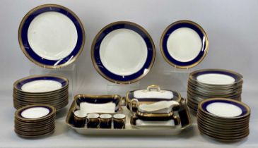 GERMAN PORCELAIN DINNERWARE, cream glazed with blue and gilt banded border, including a large