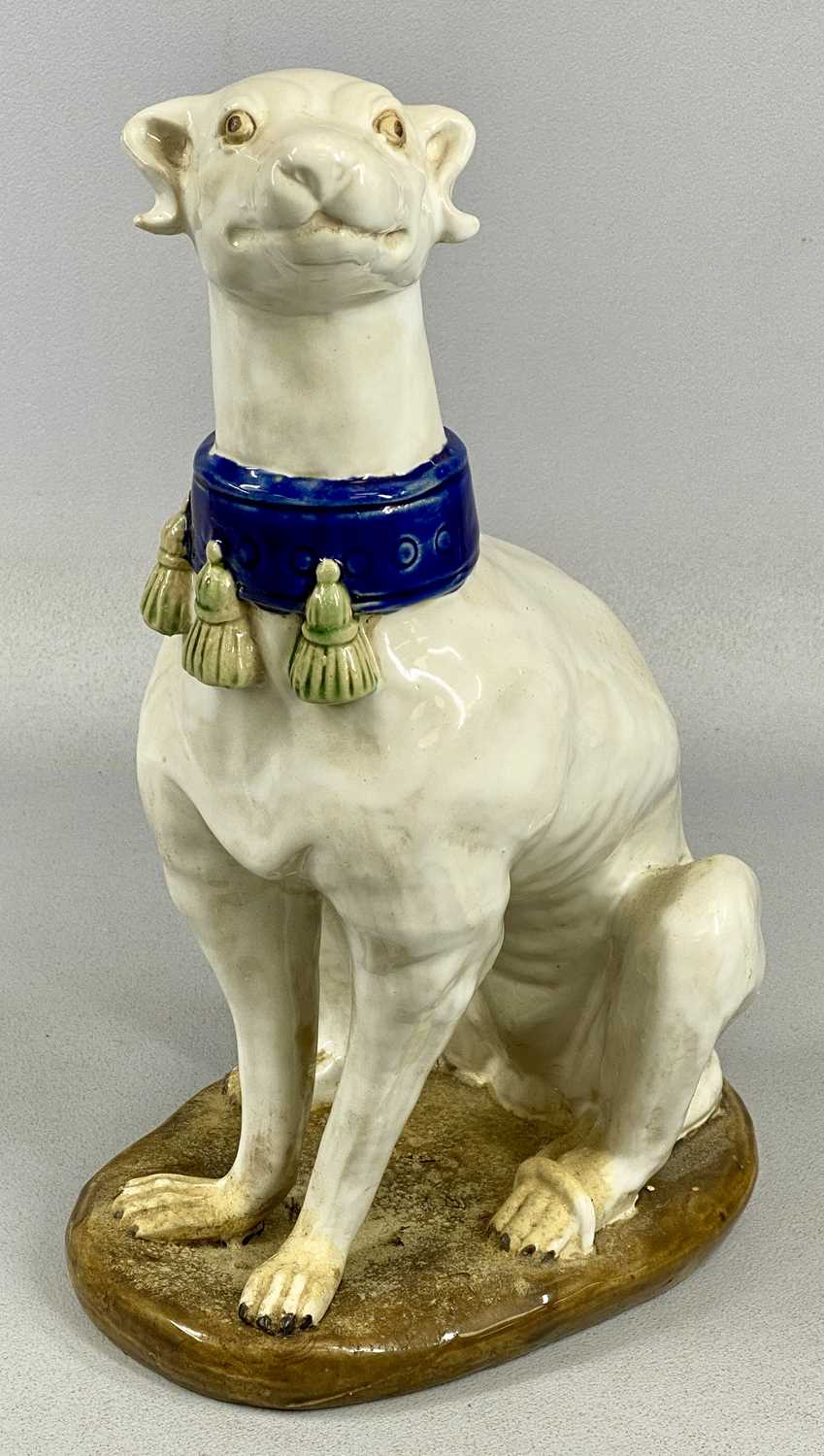 PAIR OF ITALIAN MAJOLICA GREYHOUNDS 20th century, seated and in cream glaze with tassled blue - Image 2 of 5