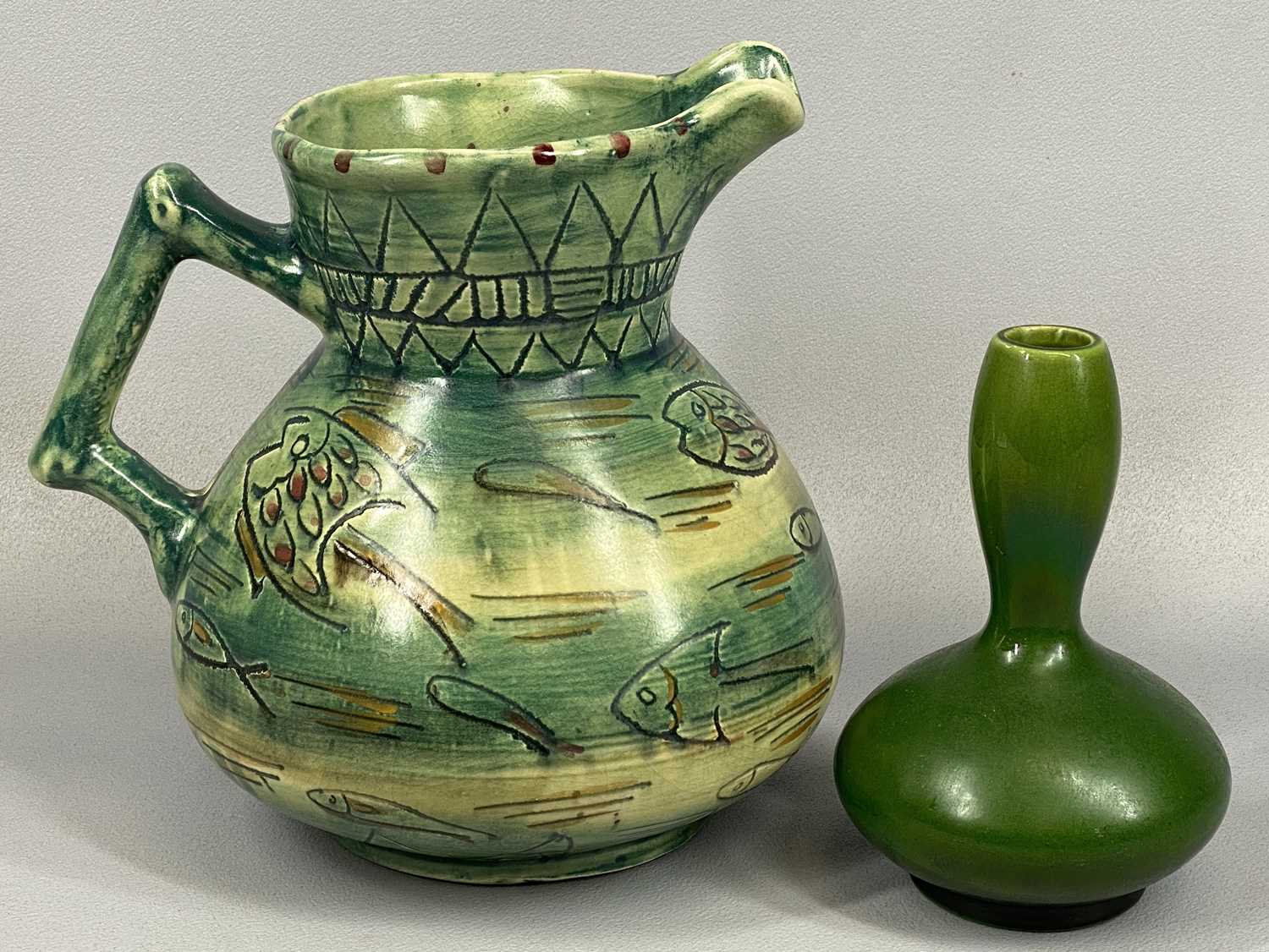 MABEL LEIGH SHORTER JUG, green and cream glazed and with incised decoration of fish, various