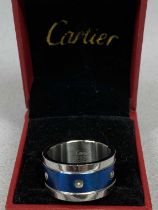 WHITE & BLUE METAL RING, the centre set with a band of screws (one missing), marked 'Cartier 750