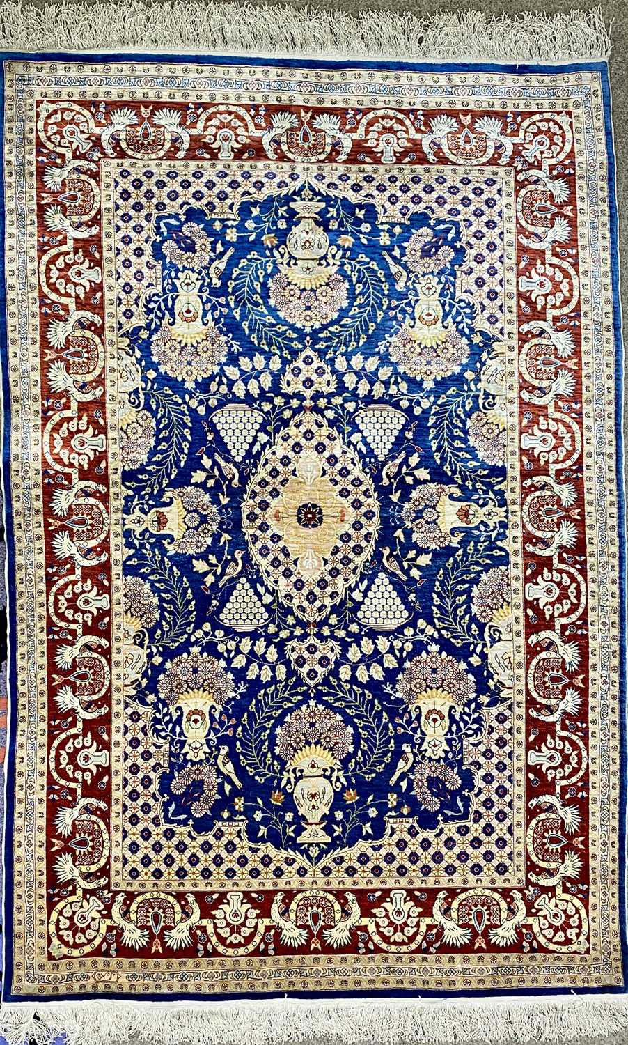 TURKISH HAND MADE SILK CARPET, blue, red and cream ground, centre field with oval medallion, birds