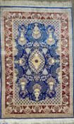 TURKISH HAND MADE SILK CARPET, blue, red and cream ground, centre field with oval medallion, birds