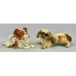 TWO CERAMIC DOG FIGURES comprising Eve Pearce Papillon, signed to base, 30.5cms (l) and a Goebel