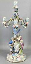 CONTINENTAL PORCELAIN THREE-BRANCH CANDELABRA, floral encrusted base modelled with two figures in