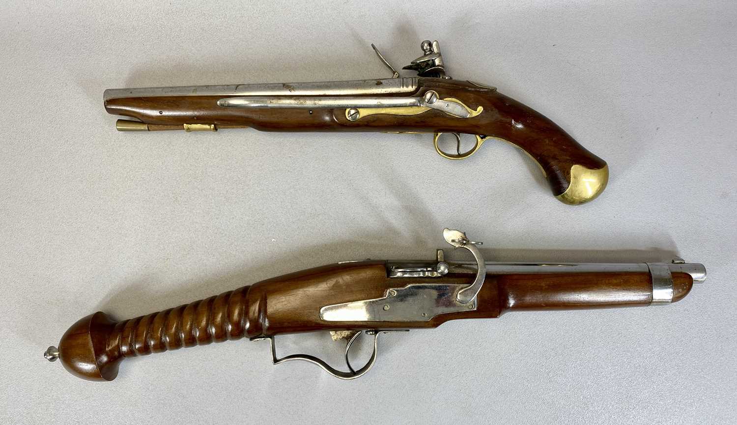 TWO REPLICA PISTOLS, Flintlock Tower pistol with ramrod, stamped on the lock plate, 50cms L, and a