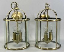 MODERN CYLINDRICAL PENDANT LANTERN LIGHT FITTINGS, a pair, brushed brass frames, curved clear