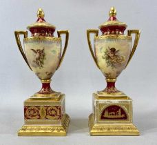 ROYAL VIENNA PORCELAIN TWO HANDLED LIDDED URNS, a pair, late 19th/early 20th century, on square