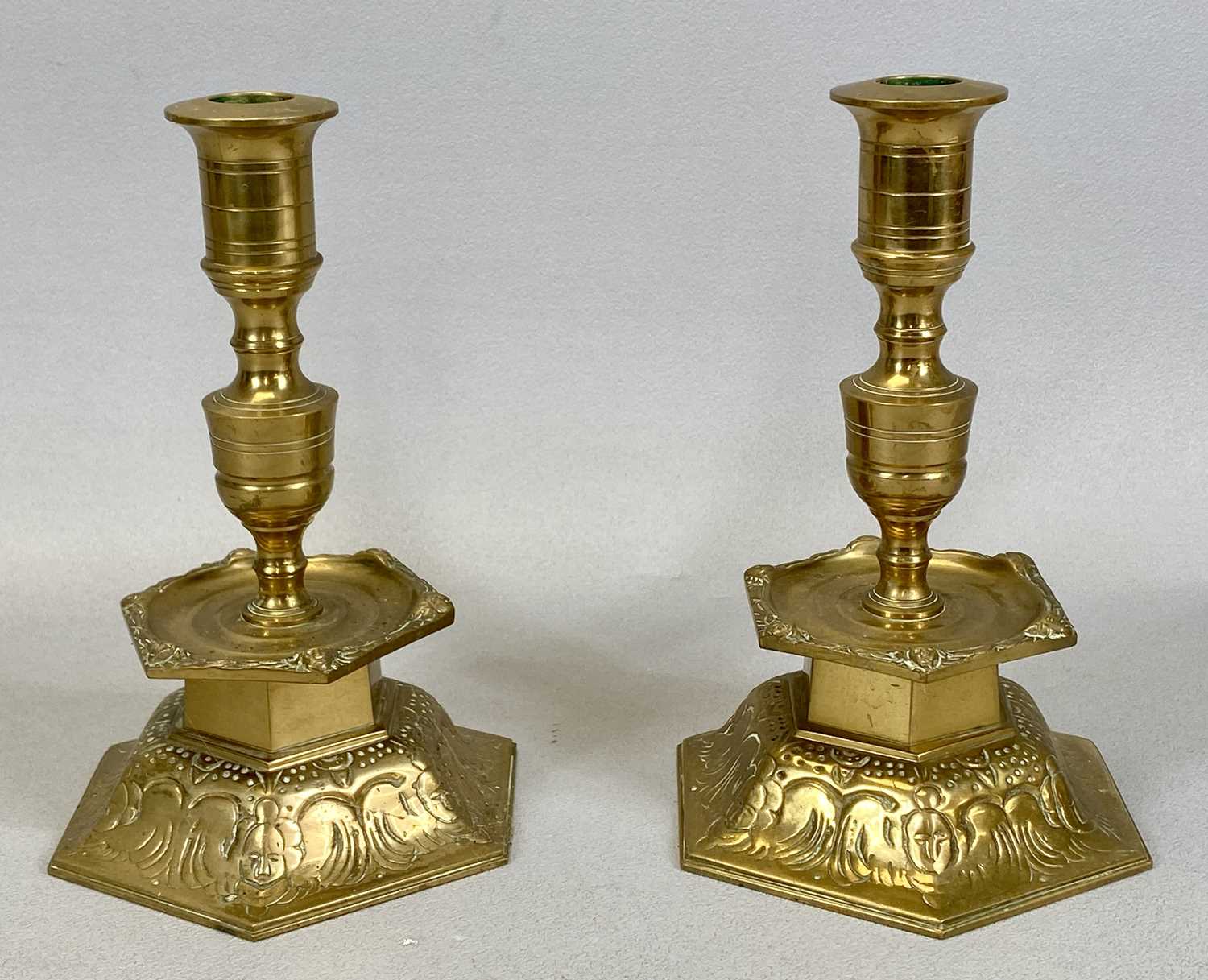 PAIR OF YSTAD METALL SWEDISH CAST BRASS CANDLESTICKS, with hexagonal mid column drip trays and domed