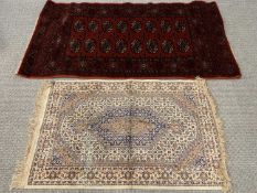TWO SMALL EASTERN RUGS red ground with medallion centre section, 160 x 83cms, cream ground with
