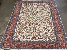 MESHED RUG, cream ground with central oblong, red and blue patterned borders and floral pattern