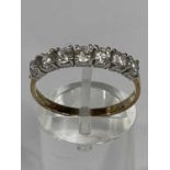 9CT GOLD RING set with band of seven cubic zirconia, size S-T, 1.7gms Provenance: deceased estate